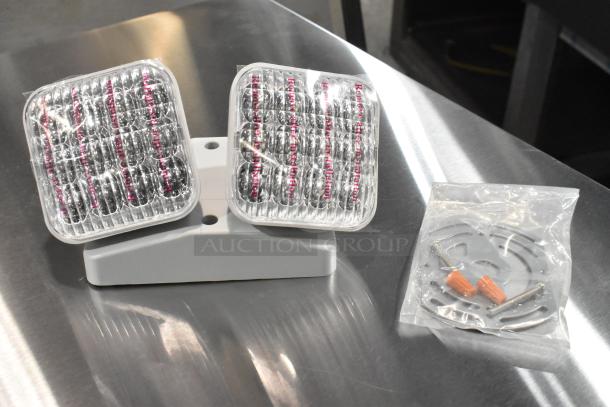 Brand new ASRLED-2-HL emergency light, model E185721-B, scratch and dent condition, includes mounting hardware.