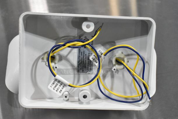 New E185721-B / ASRLED-2-HL emergency light, scratch and dent, visible wiring, tags show power specs. 8 units available.