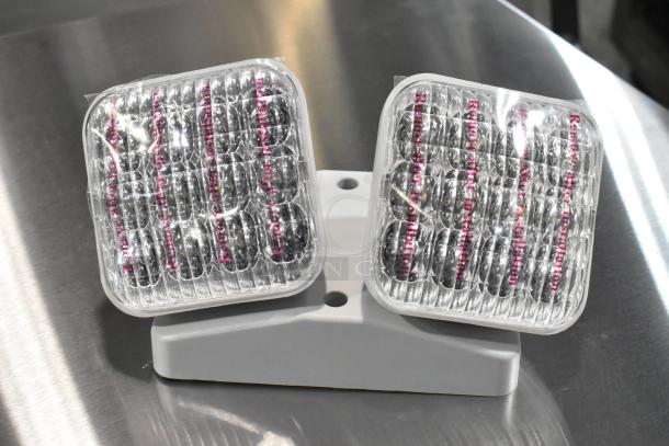 Brand new emergency light, model E185721-B / ASRLED-2-HL. Includes tags "Remove after installation."