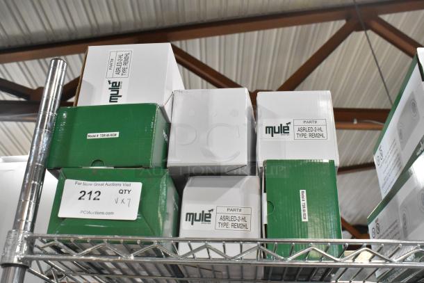 7 brand new ASRLED-2-HL TSR-W-REM emergency lights in boxes, minor scratches/dents. Markings show model and part numbers.