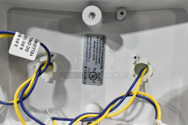 Brand new ASRLED-2-HL emergency light, UL listed, scratch and dent condition, visible wiring tags. 7 units available.
