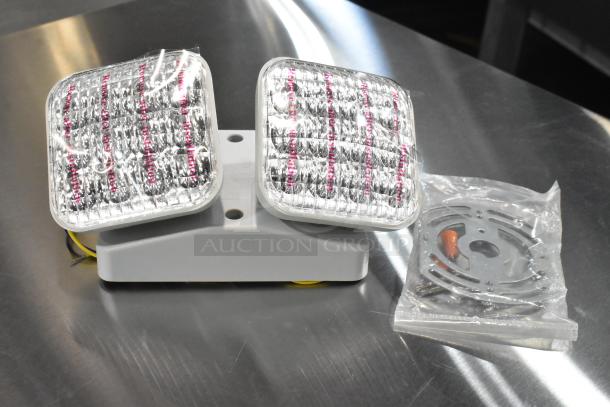 7 brand new ASRLED-2-HL/TSR-W-REM emergency lights with packaging, indicating scratch and dent condition.