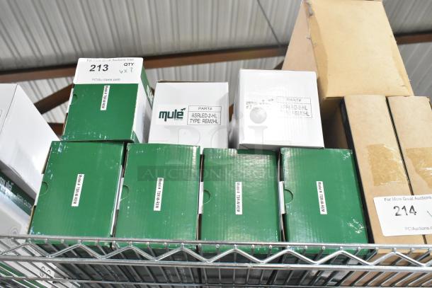 7 new scratch and dent ASRLED-2-HL/TSR-W-REM emergency lights. Part labeled boxes on shelf, some wear visible.