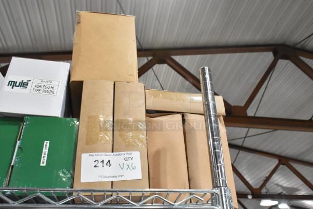 Boxes of new scratch and dent items including exit signs on metal shelving. Labels indicate quantity six, Mule brand.