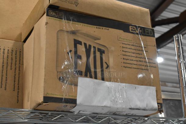 Dual-Lite brand new exit sign in a sealed box, with features listed, slight packaging wear visible.