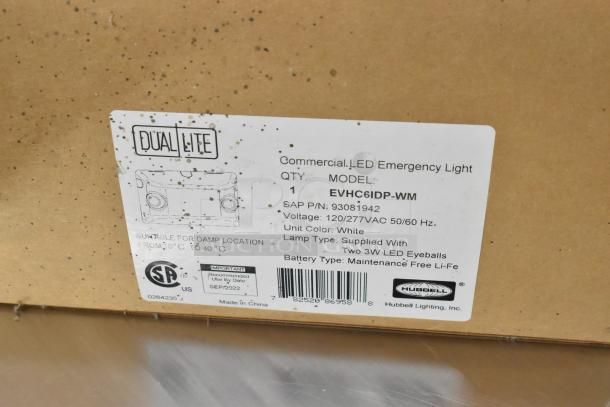 Box of Dual-Lite commercial LED emergency lights, model EVHC6IDP-WM, white color, suitable for damp locations.