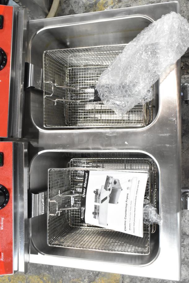 Stainless steel Avantco 177F202 dual tank fryer, new condition, includes two metal baskets, lids, and user manual.