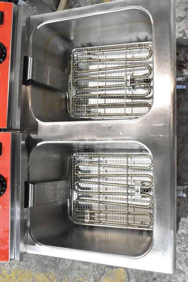 Brand new Avantco 177F202 stainless steel 30 lb. dual tank electric fryer with two metal fry baskets, 208-240V, 1 phase.