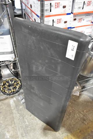 Brand new black poly ice bin lid, scratch and dent condition, rectangular shape with a label showing quantity 215.