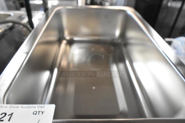 Brand new Avantco 177W50CKR 12"x20" countertop food warmer, stainless steel, 120V, slight scratch visible, auction tag shown.