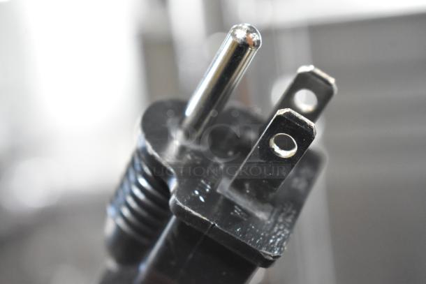 Close-up of a three-pronged electrical plug for the Avantco 177W50CKR stainless steel food warmer.