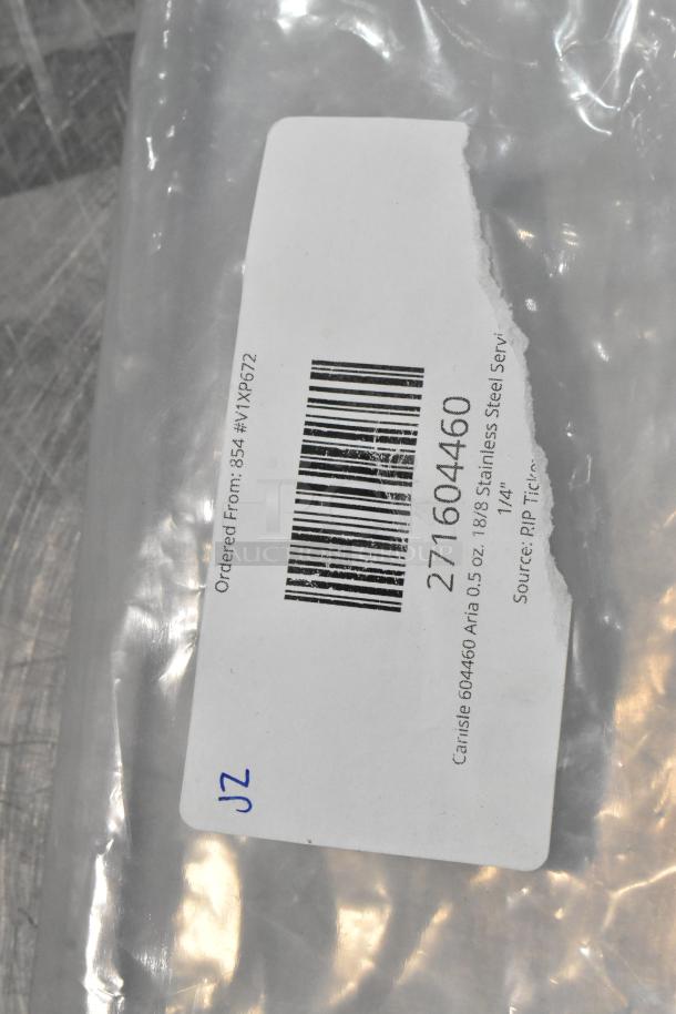 Label on plastic packaging for a Carlisle 604460 Aria 0.5 oz. stainless steel serving spoon, 9 1/4". Contains barcode.