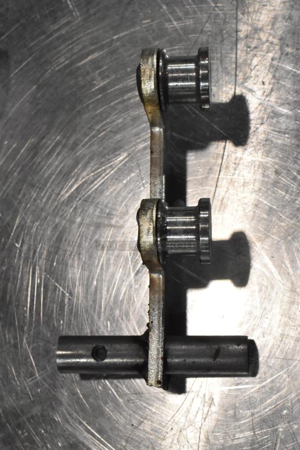 Metal component with cylindrical rollers and a bar, part of auction lot of 4 new scratch and dent items.