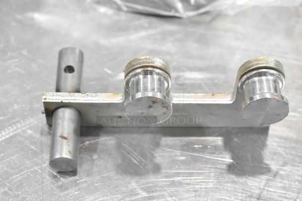 Metal component, possibly a microswitch sleeve or burner part, in new condition with slight scratches. Auction for 4 items total.