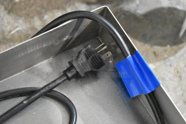 Stainless steel Avantco 177EG24N, 24" electric griddle with visible electrical plug, noted as scratch and dent condition.