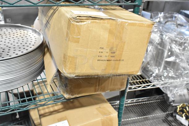 Two boxes labeled 12 kg each, containing new Baker's Mark silicone workstation mats, size 36"x24", scratch and dent.