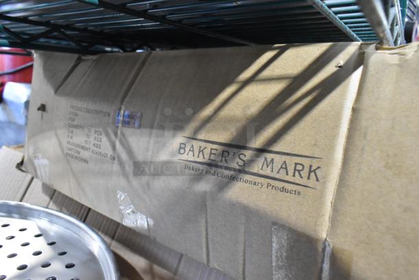 Box with Baker's Mark branding holds 12 new silicone non-stick workstation mats, 36" x 24", blue translucent, scratch and dent.