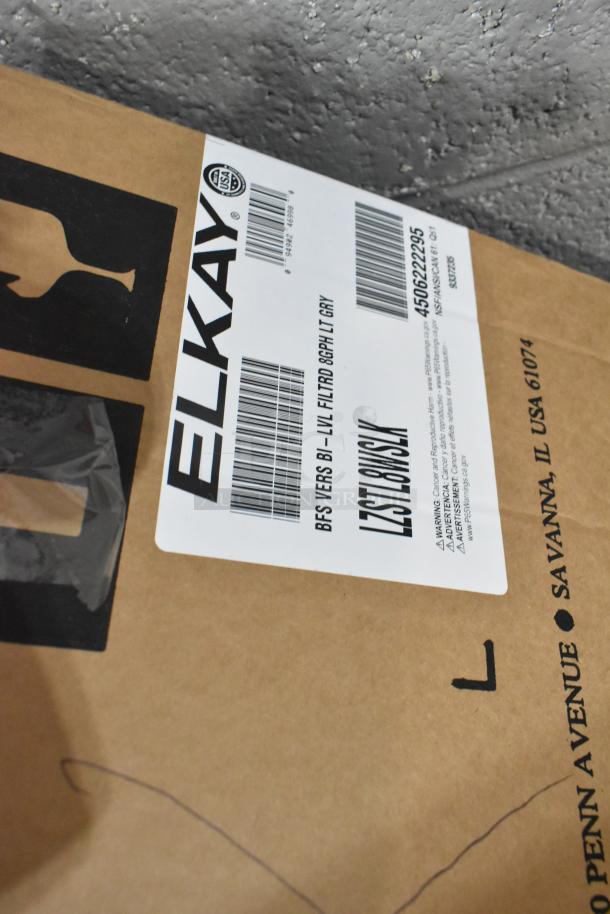 Box label of Zurn Elkay LZSTL8WSLK Bottle Filling Station, indicating model: LZSTL8WSLK, condition: new, with slight scratches.