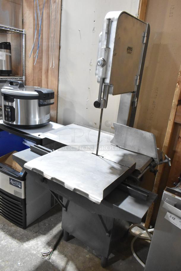 Hobart metal commercial floor-style meat saw in good condition, featuring a sturdy metal frame and cutting blade.