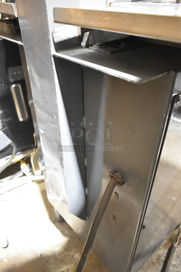 Hobart metal commercial floor-style meat saw, showing power cord and metal construction, in used condition.