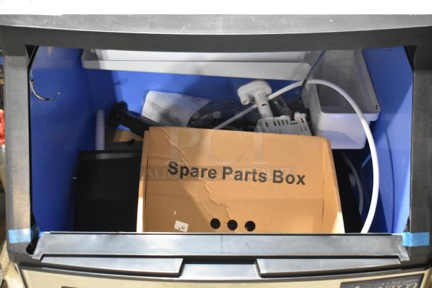 Brand new Avantco 194UCF280A ice machine with spare parts box visible inside. Stainless steel, 299 lb capacity, 115V, 1 Phase.