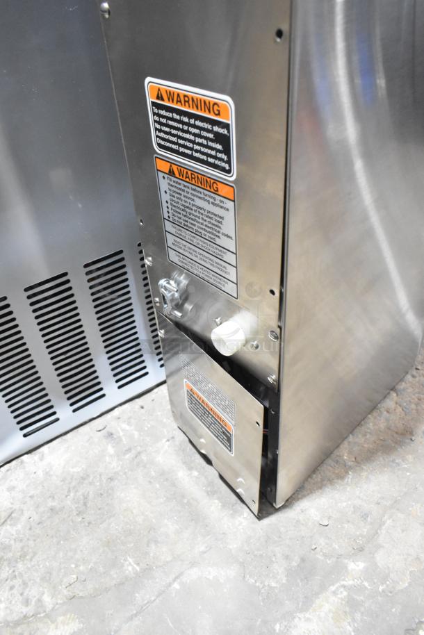 Bunn H5X stainless steel hot water dispenser, 5-gallon, 208V, with visible scratch and dent. Warning labels displayed.