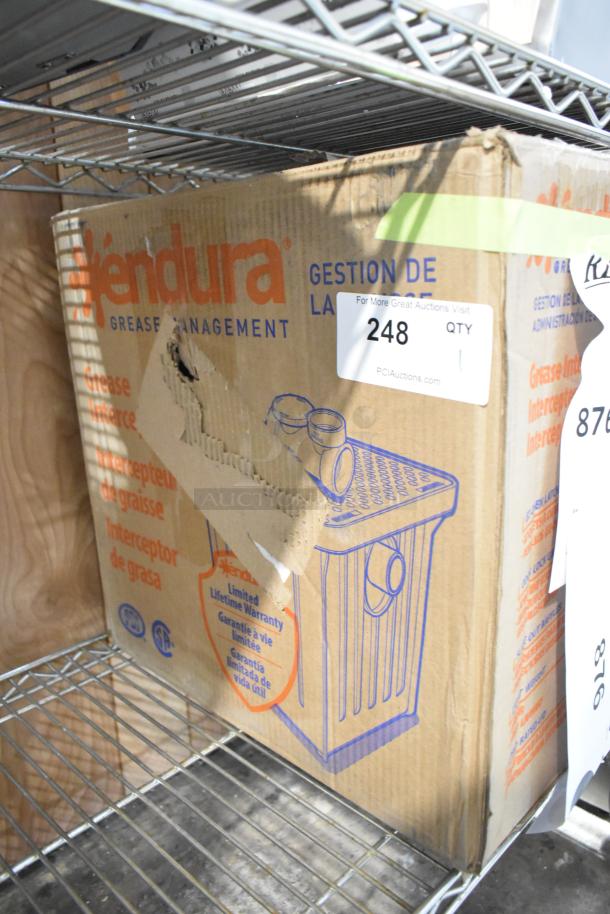 Brand new Endura 4543907A02 grease trap, 14 lb., 7 GPM, 2" hub. Box shows minor damages; warranty tag visible.