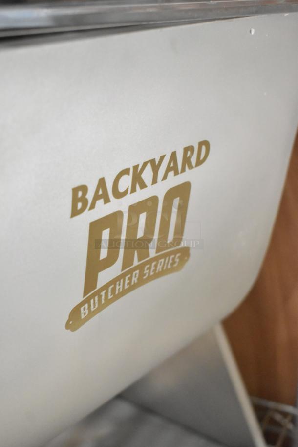 Brand new Backyard Pro BSMM-44T meat mixer, 44 lb. capacity, tilting design, removable paddles, minor scratches visible.