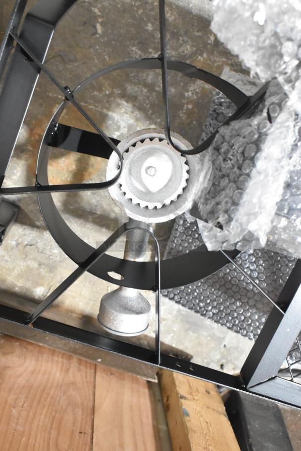 Brand new metal propane gas 2-burner range, shows minor scratches. Key features include durable build, compact design.