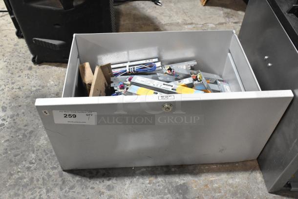 Brand new metal drawer with various Advance ballasts, scratch and dent condition, label marked "259 QTY 1."