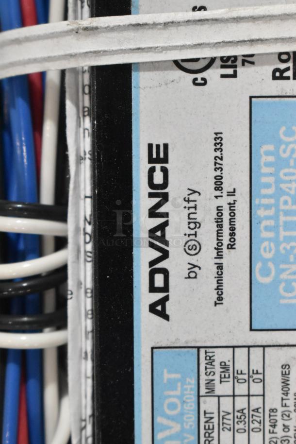 Brand new metal drawer with various Advance ballasts, labeled "Advance by Signify," showing specifications and wiring.