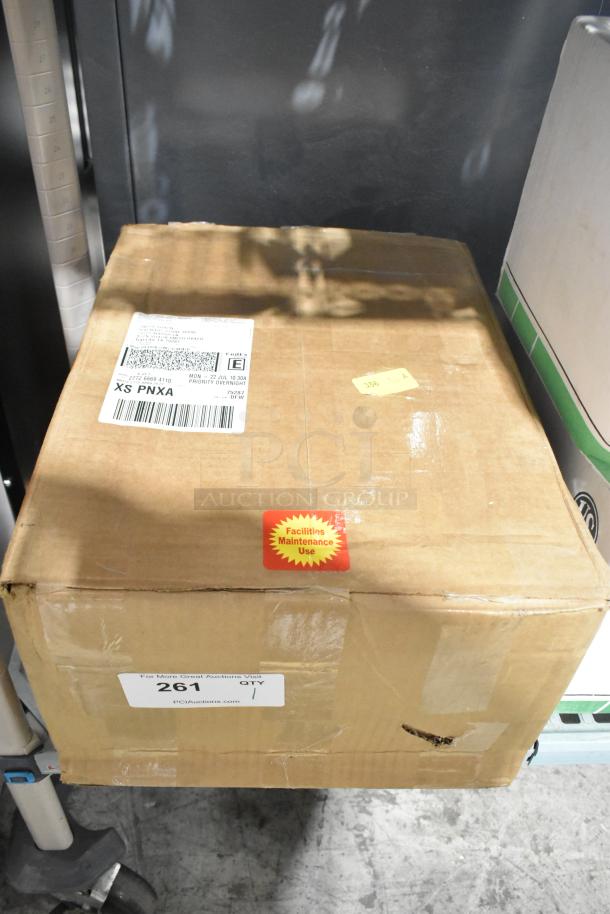 Cardboard box containing US Motors K55HXNRB-1127 condenser fan motor, 460V, 3-phase. Label indicates facilities maintenance use.