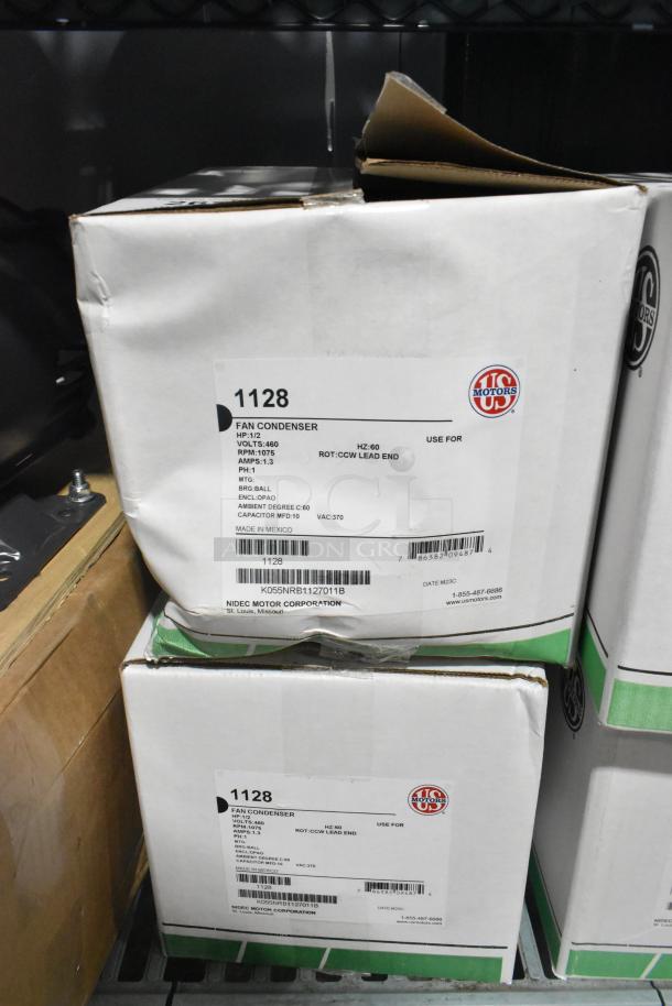 Two US Motors 1128 Fan Condenser Motors in boxes. 460 Volts, 3 Phase. Labels specify model and specifications.