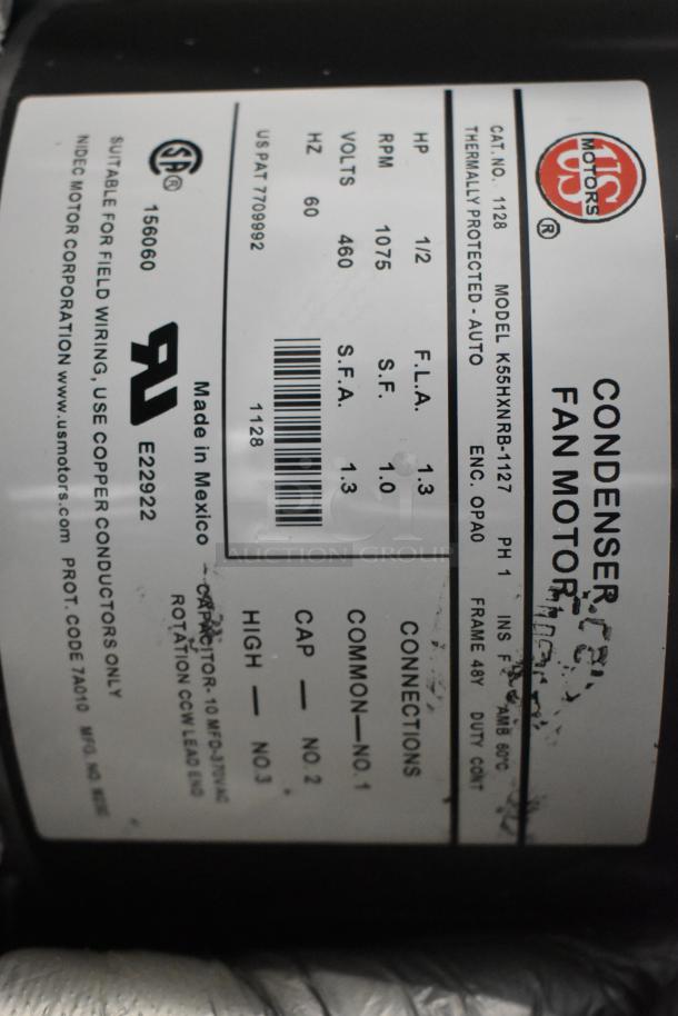 2 US Motors 1128 fan condenser motors, 460V, 3-phase. Label shows model K55HXNRB-1127, 1/2 HP, 1075 RPM, made in Mexico.