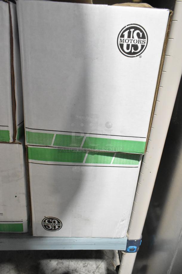 2 US Motors 1128 fan condenser motors in boxes, 460 volts, 3 phase. Boxes feature US Motors logo.