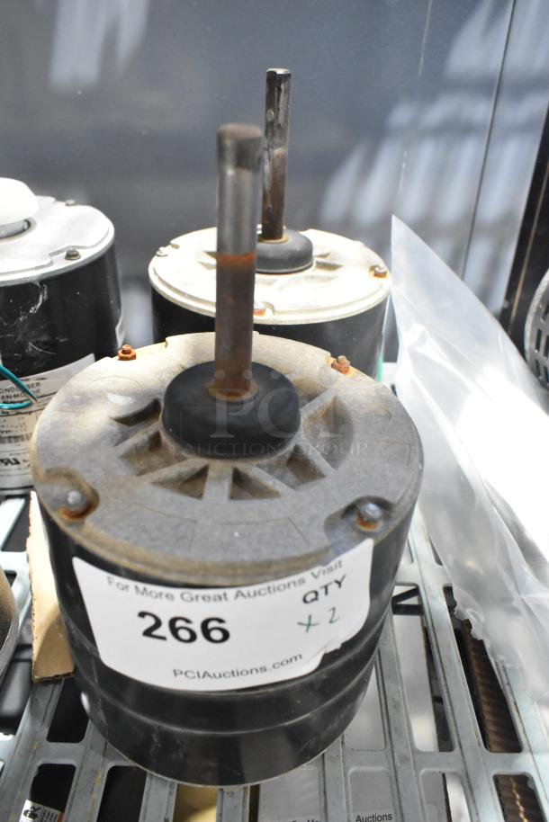 Two interlink YSLB-300-6-B003 motors, 380/460V, 1 phase, with visible rust on shafts. Auction label indicates quantity of two.