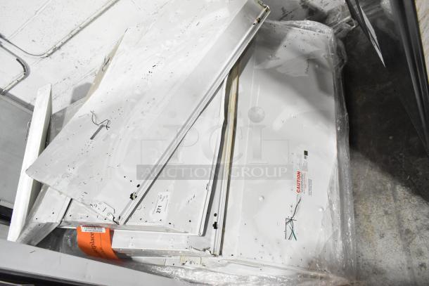 Pallet lot of used fluorescent lights, various sizes, with wires exposed. Includes caution labels and auction tag indicating lot 271.