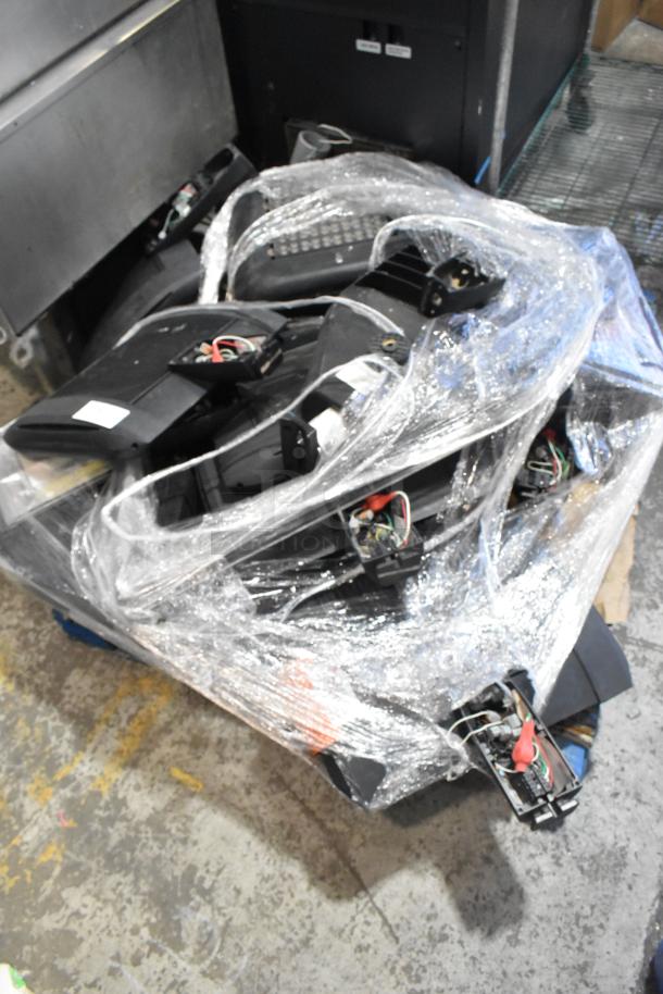 Bundle of eight various items including current light fixtures, wrapped in plastic. Items show wiring and components.