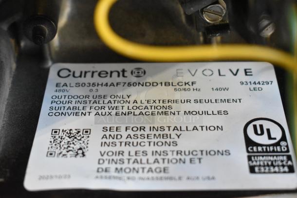 Current Evolve light fixture tag, model EALS035H4AF750NDD1BLCKF, 140W, 480V, UL certified for outdoor wet locations.