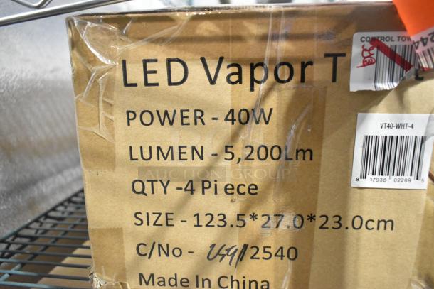 Cardboard box marked "LED Vapor Tight Light," displaying specifications: 40W, 5200 lumens, VT40-WHT-4, made in China.