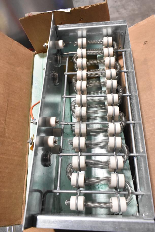 Metal box with coiled wire resistors, metal frame, and ceramic insulators. Appears in good condition, no visible labels.