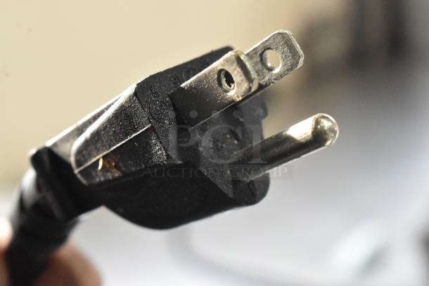 Close-up of a power plug for a 2019 VitaMix VM0145 countertop blender. Plug shows standard wear, suitable for 120 volts.