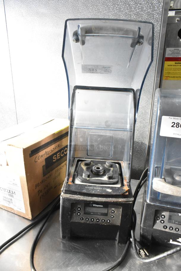 VitaMix VM0145 countertop blender with metal base and clear dome enclosure, model 036019-1305, shows signs of wear.