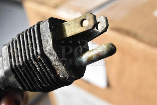 Close-up image of a worn and weathered power plug, likely part of the VitaMix VM0145 blender cord.