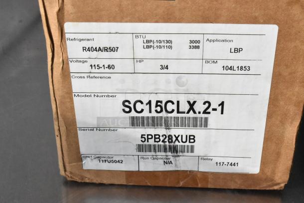 New Secop SC15CLX.2-1 compressor, 3000 BTU, 115V, 1-phase. Label shows R404A/R507 refrigerant, model, and serial number.