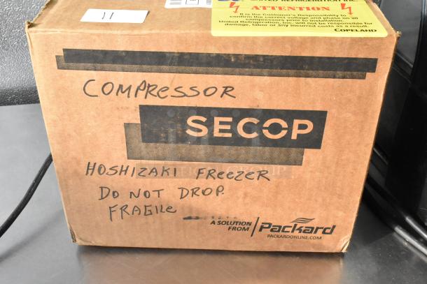 Brand new Secop SC15CLX.2-1 compressor, 3000 BTU, 115V, 1 phase, in original box. Labels indicate "Hoshizaki Freezer."
