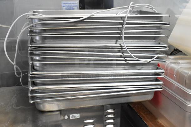 Lot of stainless steel and poly drop-in bins in various sizes, stacked. Items appear in good condition.