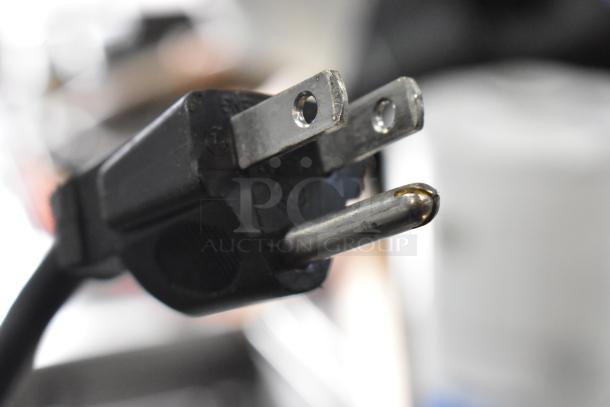 Close-up image of a power plug. Please provide an image of the Crathco D25-3 beverage dispenser for detailed description.