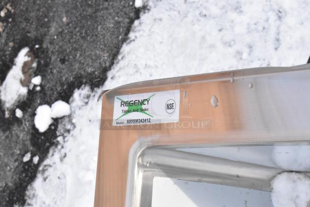 Regency 600SM242412 stainless steel mop sink, 24"x24"x12", new condition, minor scratches. Label shows model and NSF approval.