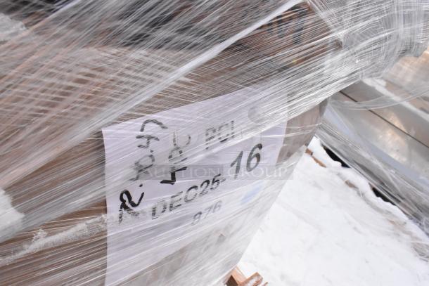 Pallet wrapped with label showing "DEC25-16," containing scratch and dent items including drying rack and stainless steel sink.